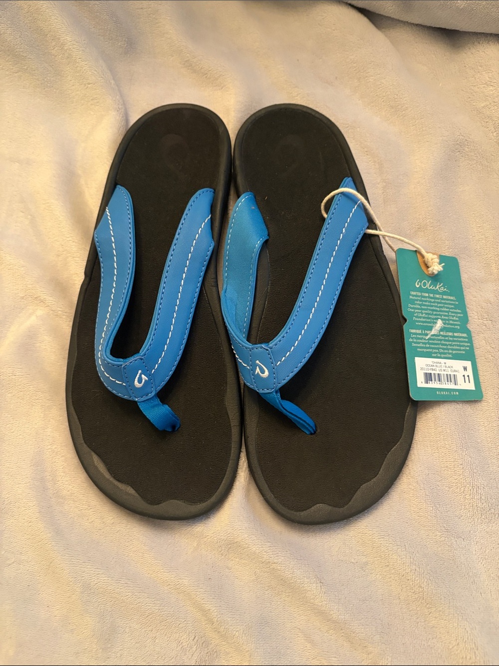 OluKai women’s Black Sandals with Bright Blue Straps